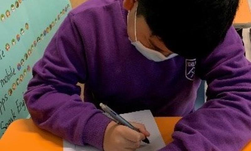 Students concentrate on expressing themselves through the story writing.
